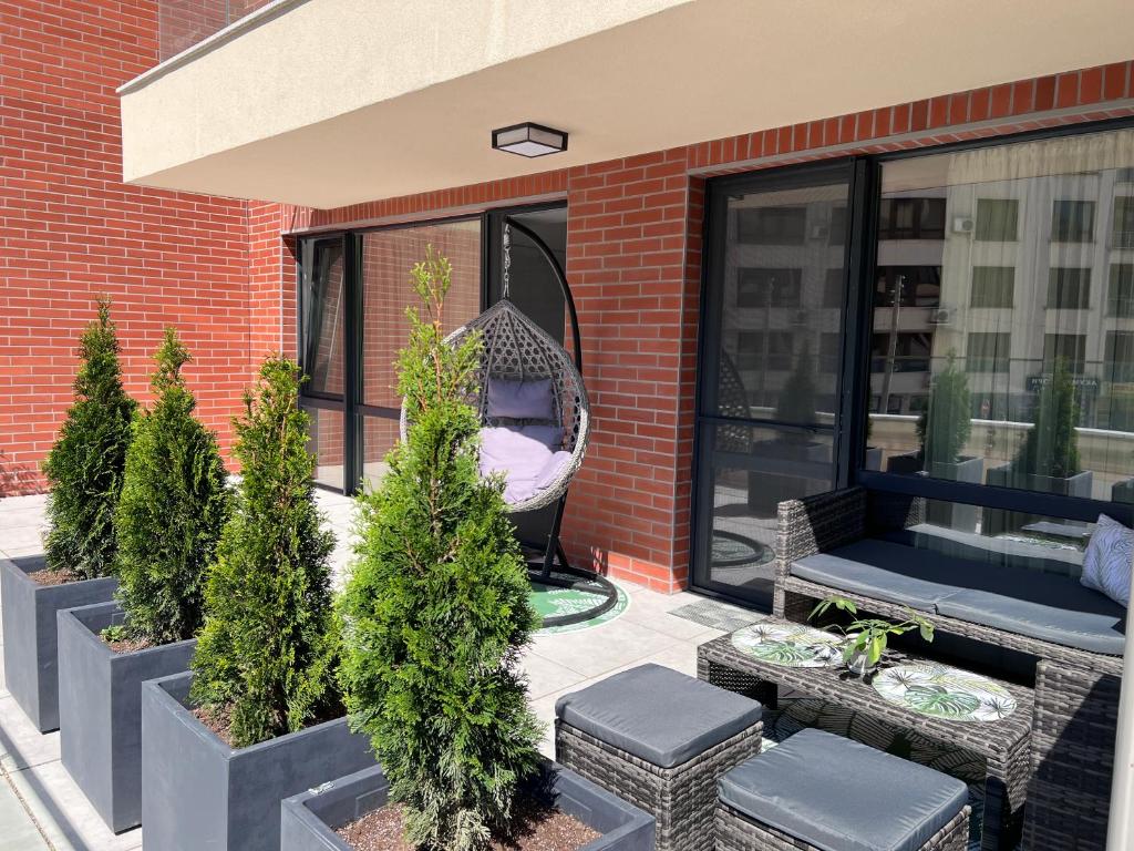 a porch with a hammock on the side of a building at A-Brilliant, NEW! spacious & modern apartment in Varna whit GARAGE in Varna City