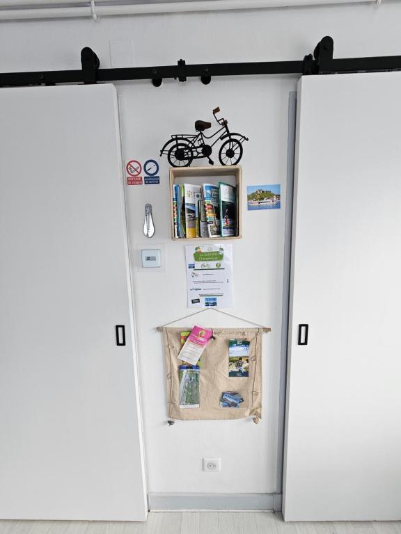 a white refrigerator with a motorcycle on it at Le Bellevue in Givet