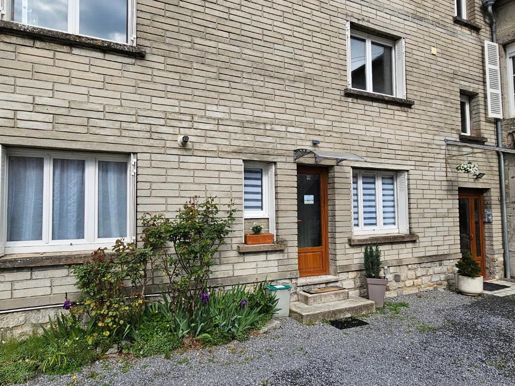 a brick house with a brown door and windows at Le Bellevue in Givet