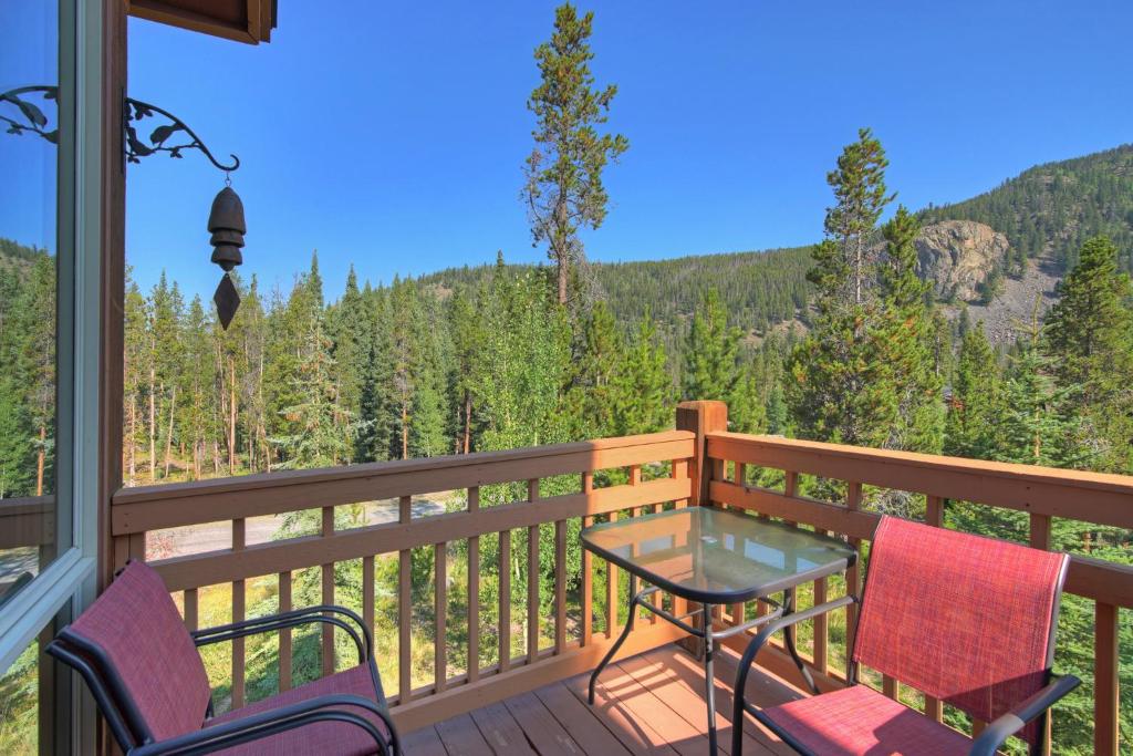 a balcony with a table and chairs and a view of the mountains at East Keystone by Keystone Resort in Keystone