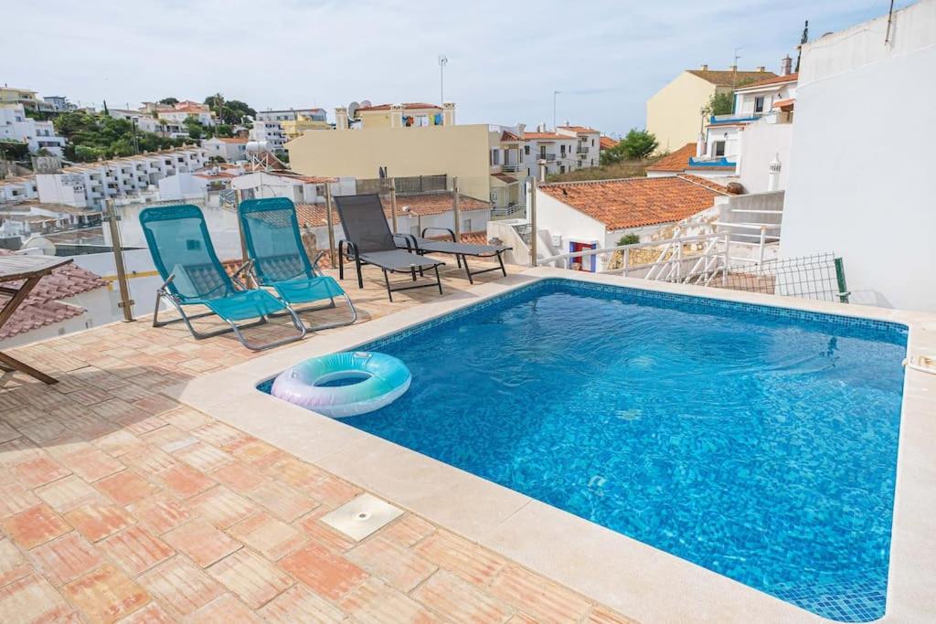 a swimming pool on the roof of a building at Colors Pool House in Carvoeiro