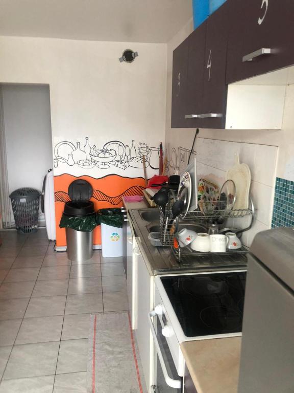 a kitchen with a sink and a stove top oven at A 20 minutes de Paris in Sarcelles