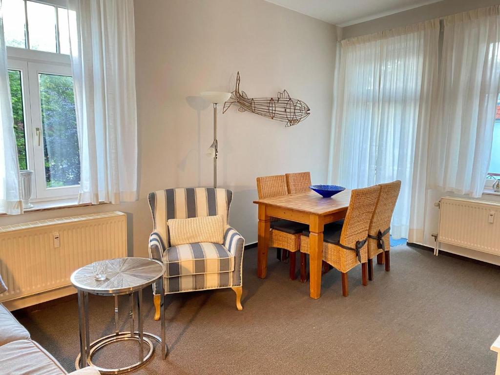 a living room with a dining room table and chairs at Residenz-Ostseewind-Wohnung-17-255 in Kühlungsborn