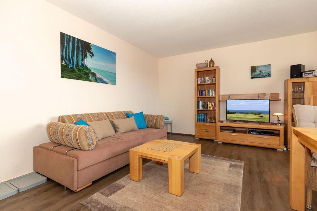 a living room with a couch and a tv at Yachthafenresidenz-Wohnung-8212-855 in Kühlungsborn