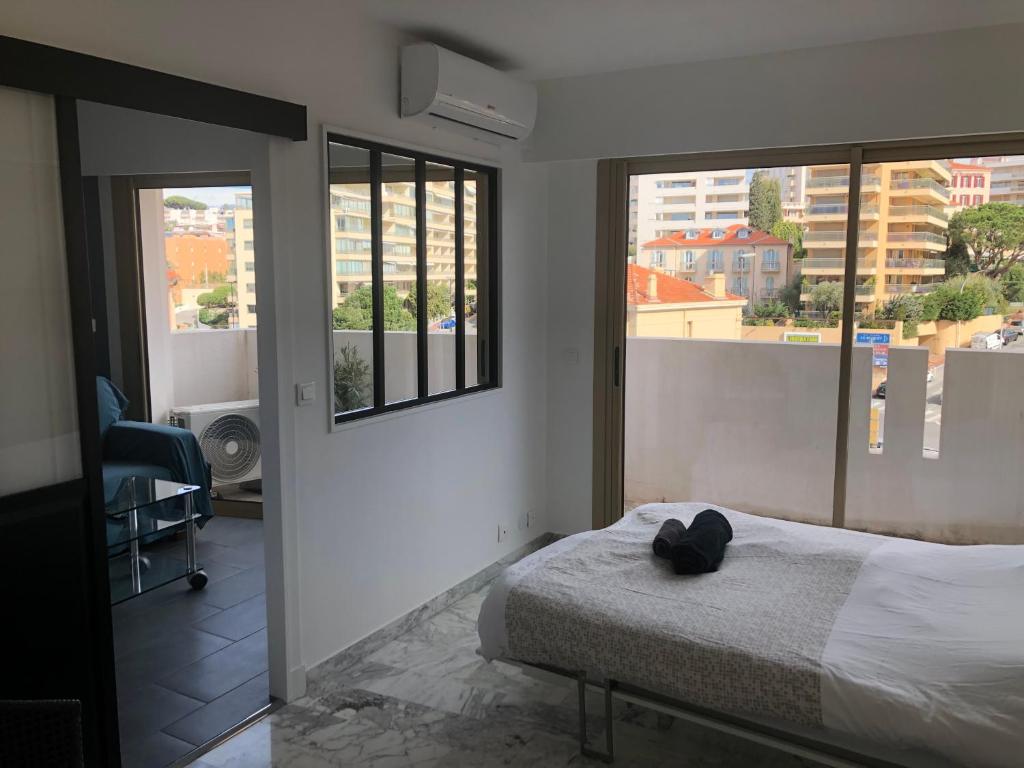 a bedroom with a bed and a view of a city at Esterel Terrasses, roof top, 10mn Palais des festivals in Cannes