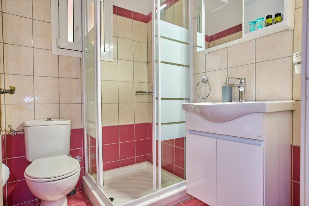 a bathroom with a toilet and a sink at Logas Beach Studios Peroulades Corfu in Peroulades