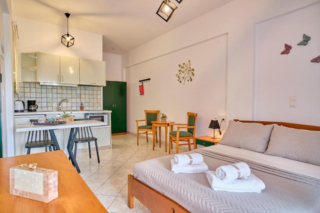 a living room with a couch and a kitchen at Logas Beach Studios Peroulades Corfu in Peroulades