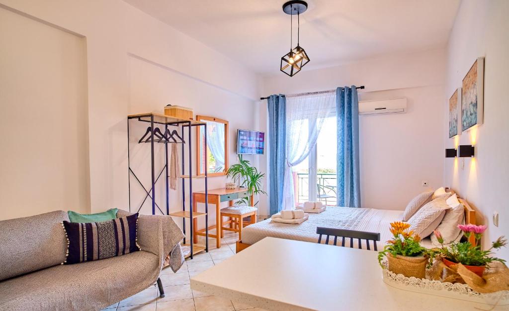 a living room with a couch and a table at Logas Beach Studios Peroulades Corfu in Peroulades