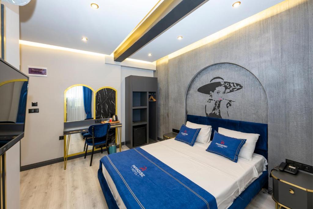 a bedroom with a bed with blue pillows at İstanbul Paradise Hotel in Istanbul
