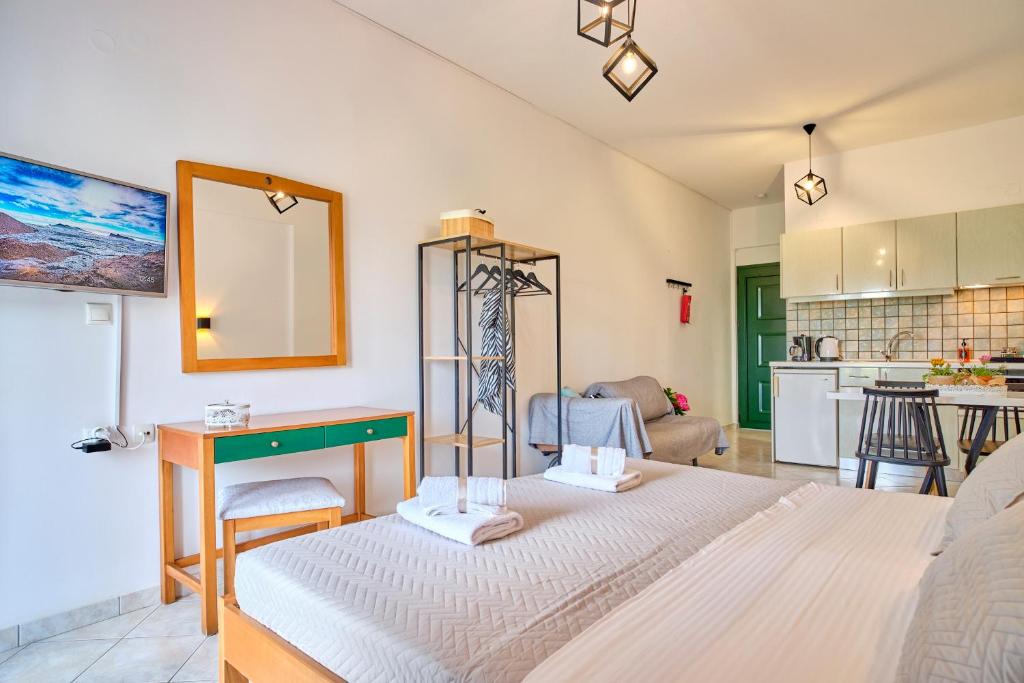 a living room with a bed and a kitchen at Logas Beach Studios Peroulades Corfu in Peroulades