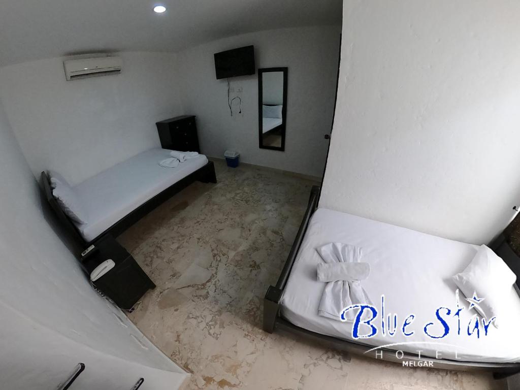 Postel nebo postele na pokoji v ubytování Blue Star Hotel