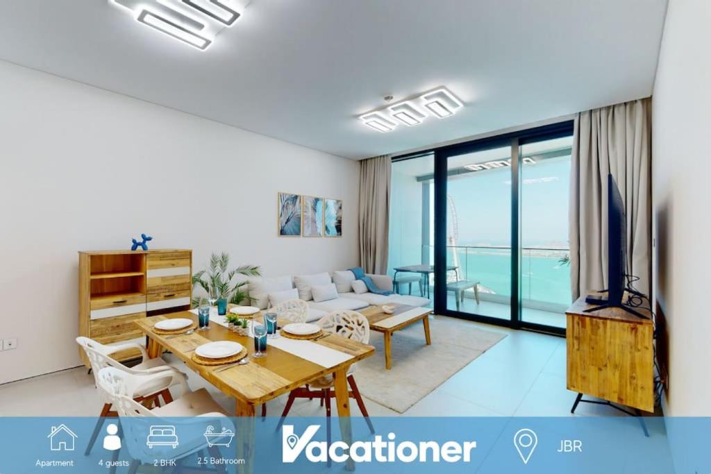 a living room with a dining table and a couch at Address Beach Residence, JBR - Vacationer in Dubai