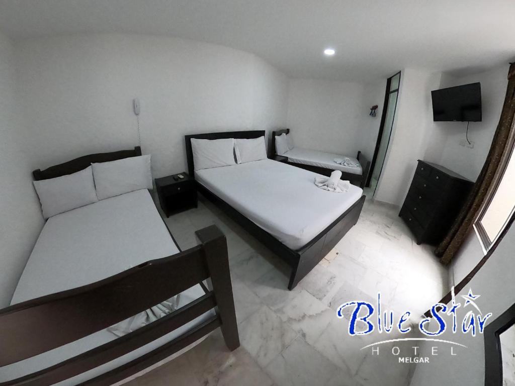 Postel nebo postele na pokoji v ubytování Blue Star Hotel