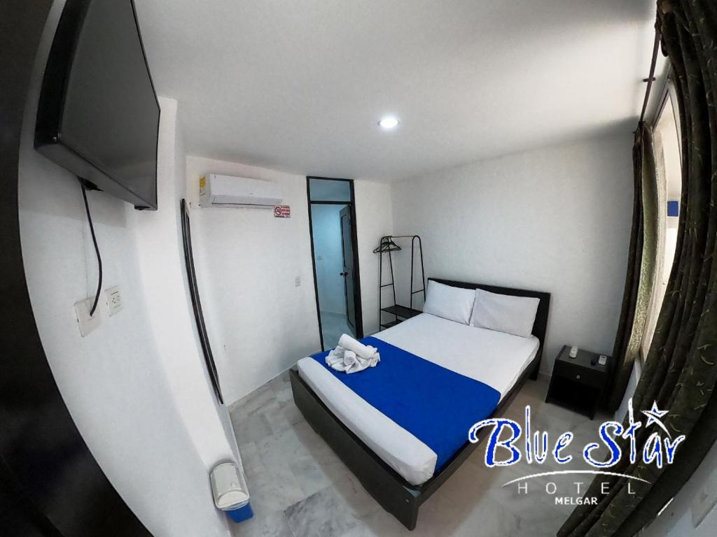 Postel nebo postele na pokoji v ubytování Blue Star Hotel