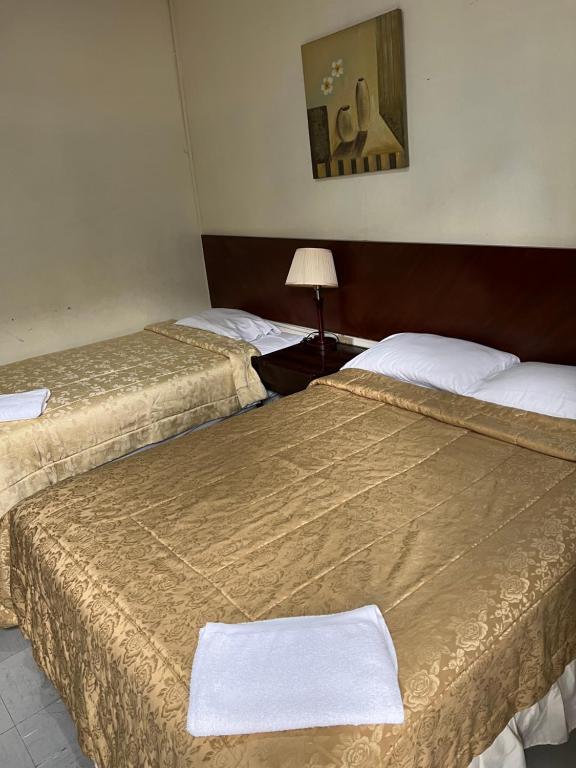Postel nebo postele na pokoji v ubytování Hotel Rizzo