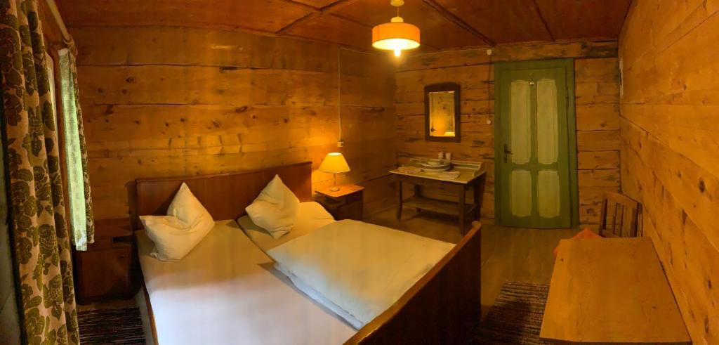 a bedroom with a bed in a wooden cabin at Grawandhütte in Ginzling