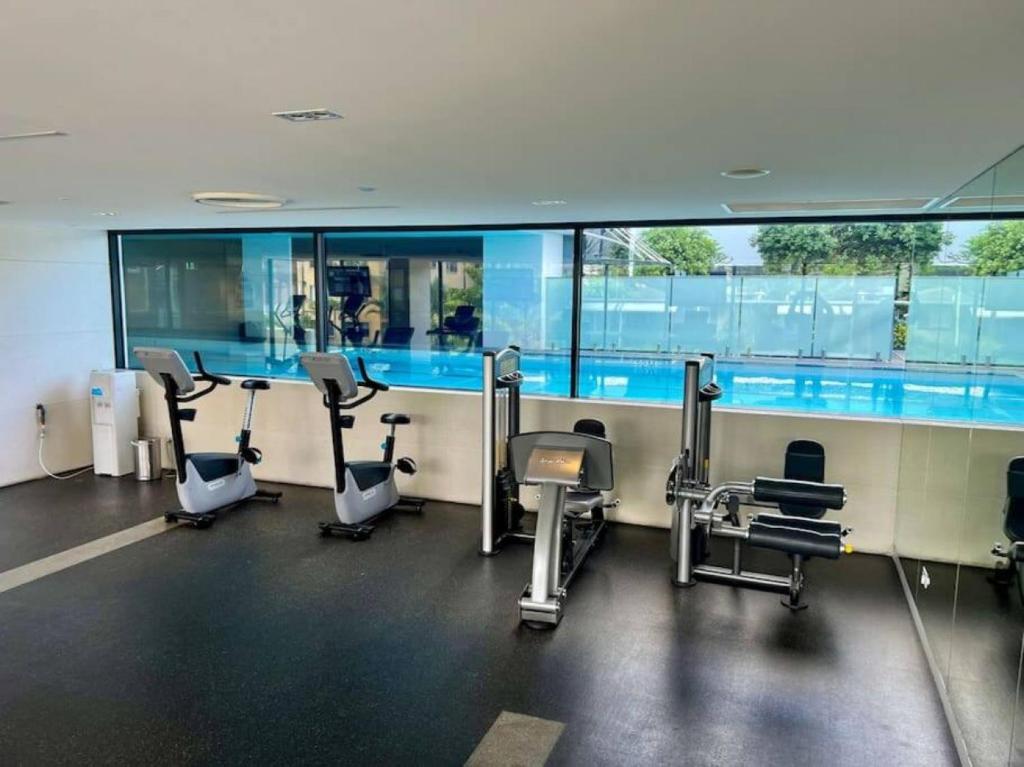 a gym with cardio equipment in a building at Oracle 11th floor Tower 1 - GC Getaways in Gold Coast