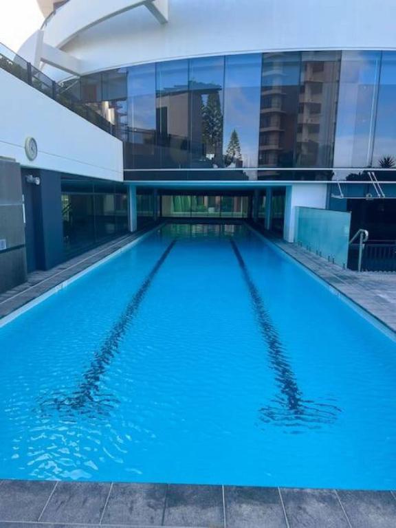 a large swimming pool in front of a building at Oracle 11th floor Tower 1 - GC Getaways in Gold Coast