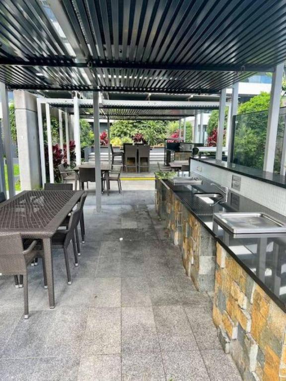 an outdoor patio with tables and benches and tables at Oracle 11th floor Tower 1 - GC Getaways in Gold Coast