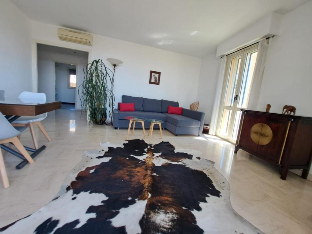 ein Wohnzimmer mit einem blauen Sofa und einem Teppich in der Unterkunft Luxurious sea view apartment Cannes Vieux Cannet in Le Cannet