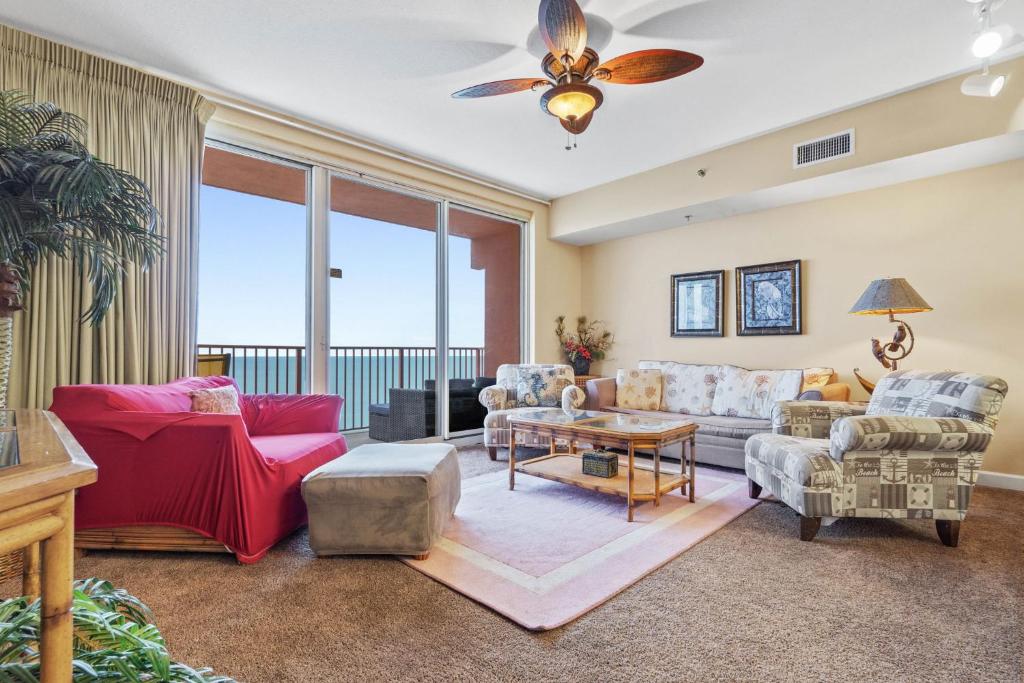 a living room with a couch and a table at Shores of Panama #2302 by Nautical Properties in Panama City Beach