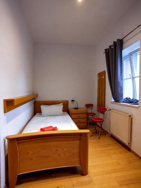 a bedroom with a bed and a window at Domhotel in Sankt Wendel