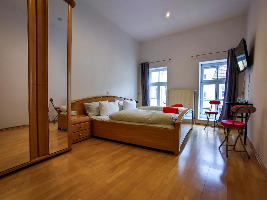 a bedroom with a bed and a large mirror at Domhotel in Sankt Wendel