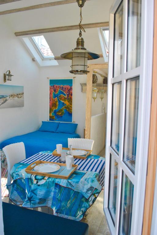 a dining room with a blue table and a window at Apartment Mediterraneo Blue Sky in Perast