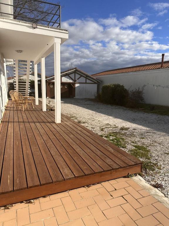 a wooden deck on the side of a house at Maison de vacances Bisca in Biscarrosse