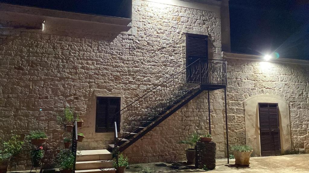 a brick building with a staircase on it at night at La dimora nonna Eugy in Polignano a Mare