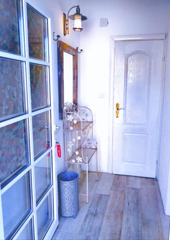 a hallway with a white door and a window at Apartment Mediterraneo Blue Sky in Perast