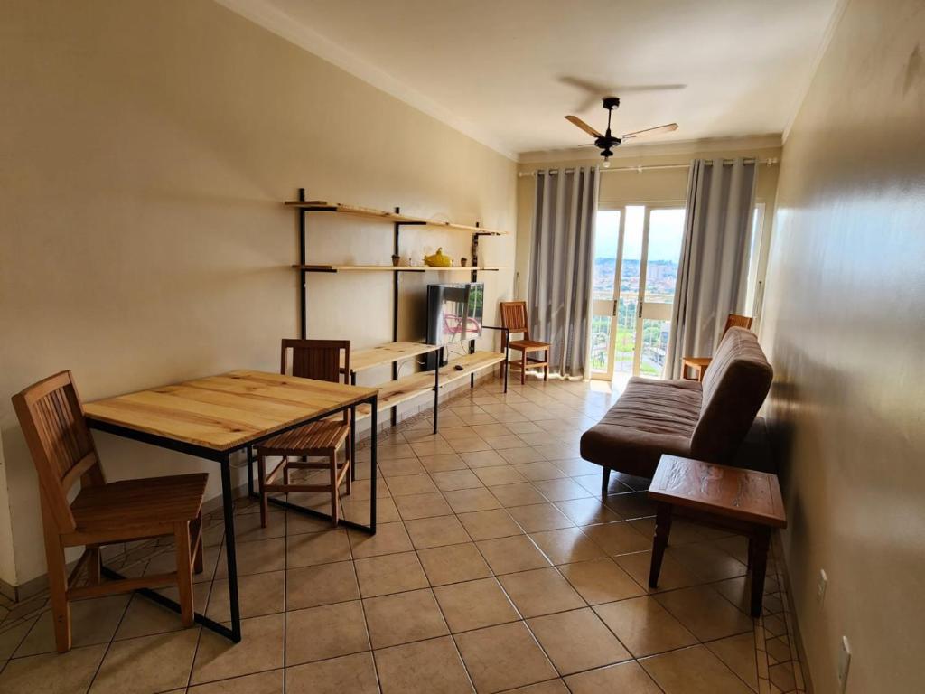 a living room with a table and chairs at RelaxRP in Ribeirão Preto