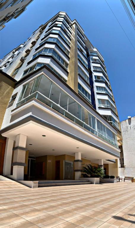 a tall building with a lot of windows at Apartamento Condado de Majorca in Capão da Canoa