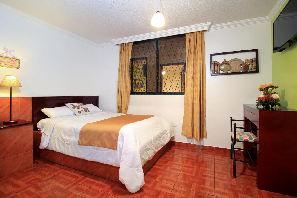 Un pat sau paturi într-o cameră la La Rosario