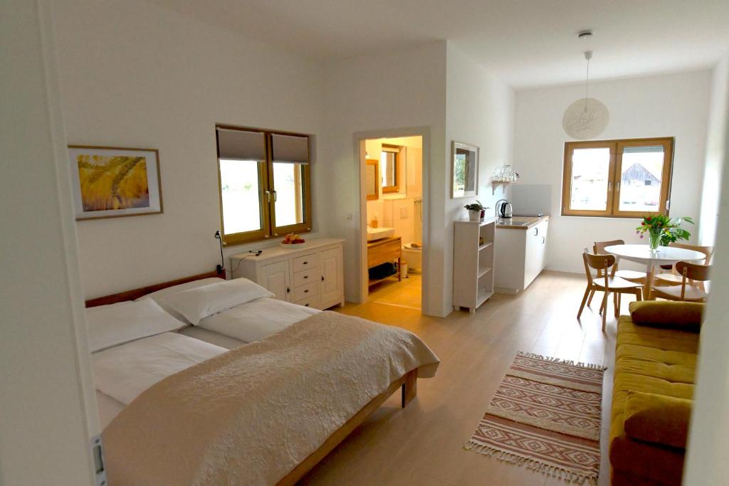 a bedroom with a bed and a table and a kitchen at Family Ranch Urlaub am Pferdehof 