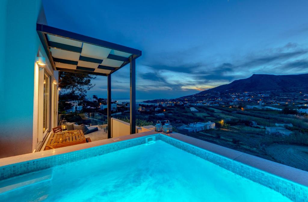 a swimming pool on the roof of a house at Villa Mare Syros in Finikas