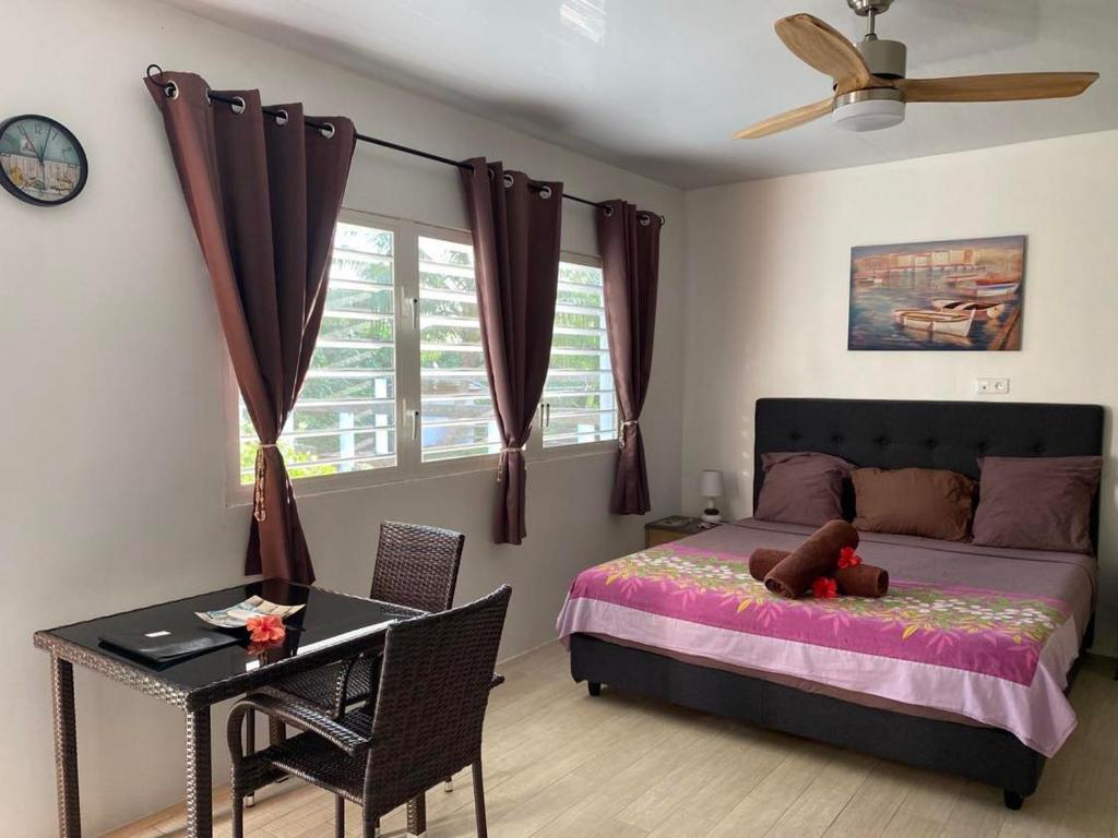 a bedroom with a bed with a teddy bear on it at Bora Bora Fare Sophia in Bora Bora