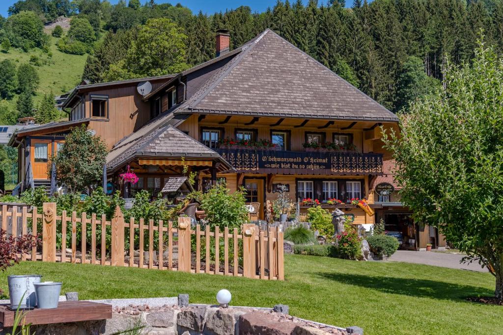 a large wooden house with a fence in front of it at Haus Erika in Wieden