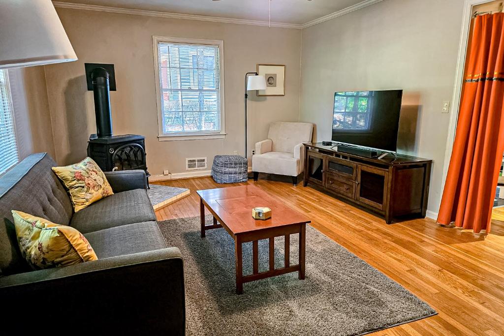 a living room with a couch and a flat screen tv at Sycamore Place Duplex in Atlanta