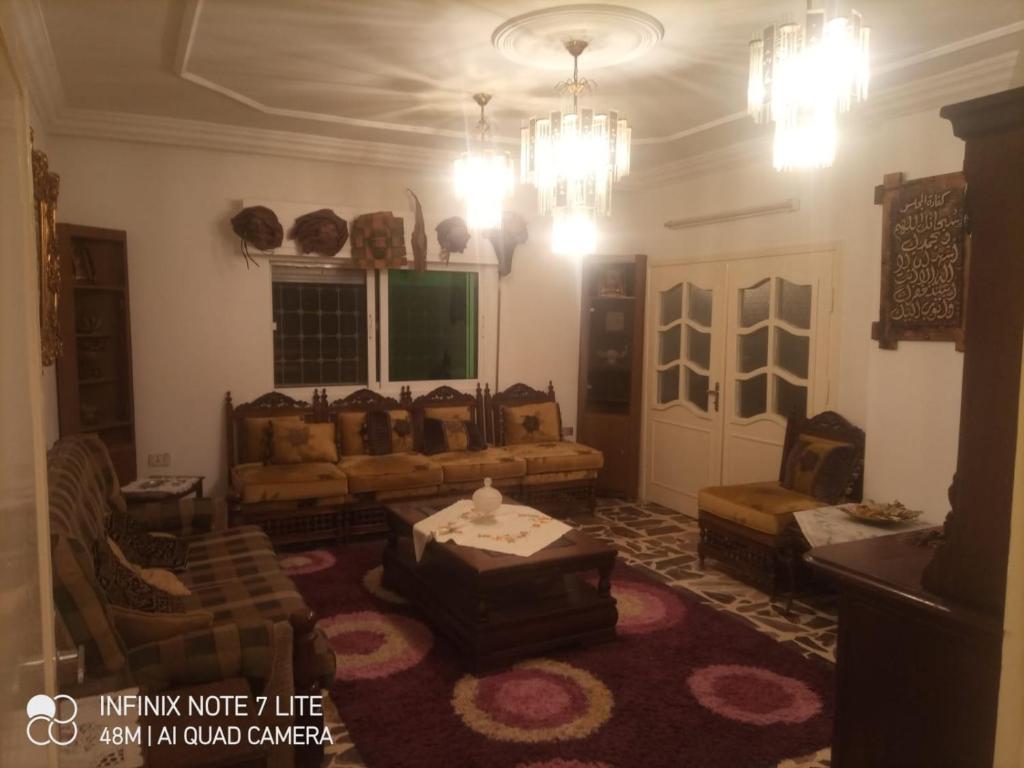 a living room with a couch and a table at Decapolis in Irbid