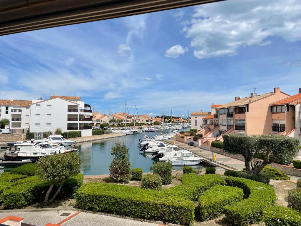 Una vista de un puerto deportivo con barcos en el agua. en Hispaniola, avec vue sur la marina et parking privé, en Saint-Cyprien