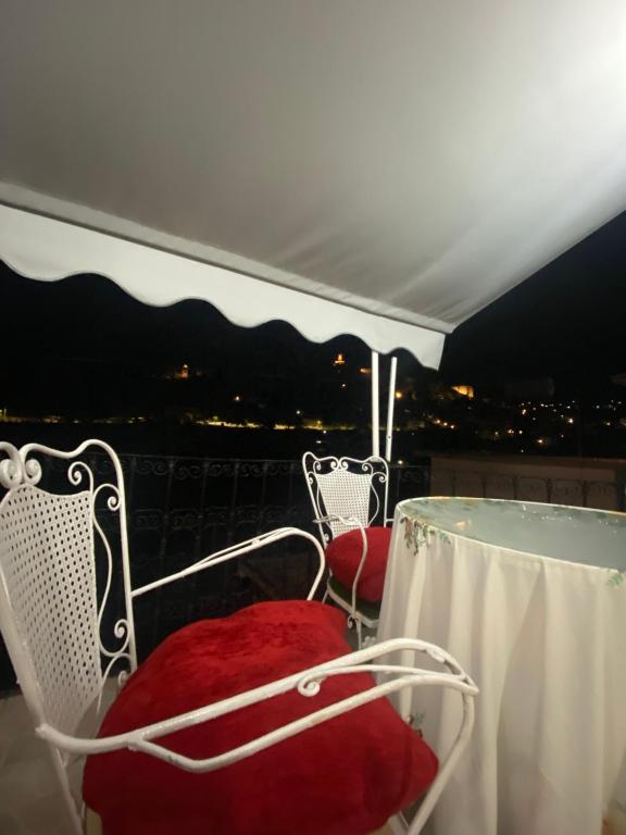 a chair sitting under a canopy on a roof at Marko's House in Gjirokastër