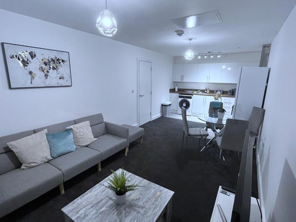 a living room with a couch and a table and a kitchen at Nottingham Brand New 1BR Apt w/ Full Kitchen City in Nottingham