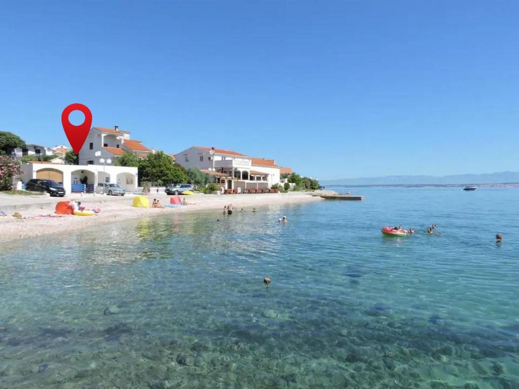 a group of people in the water at a beach at Apartments by the sea Preko, Ugljan - 21319 in Preko