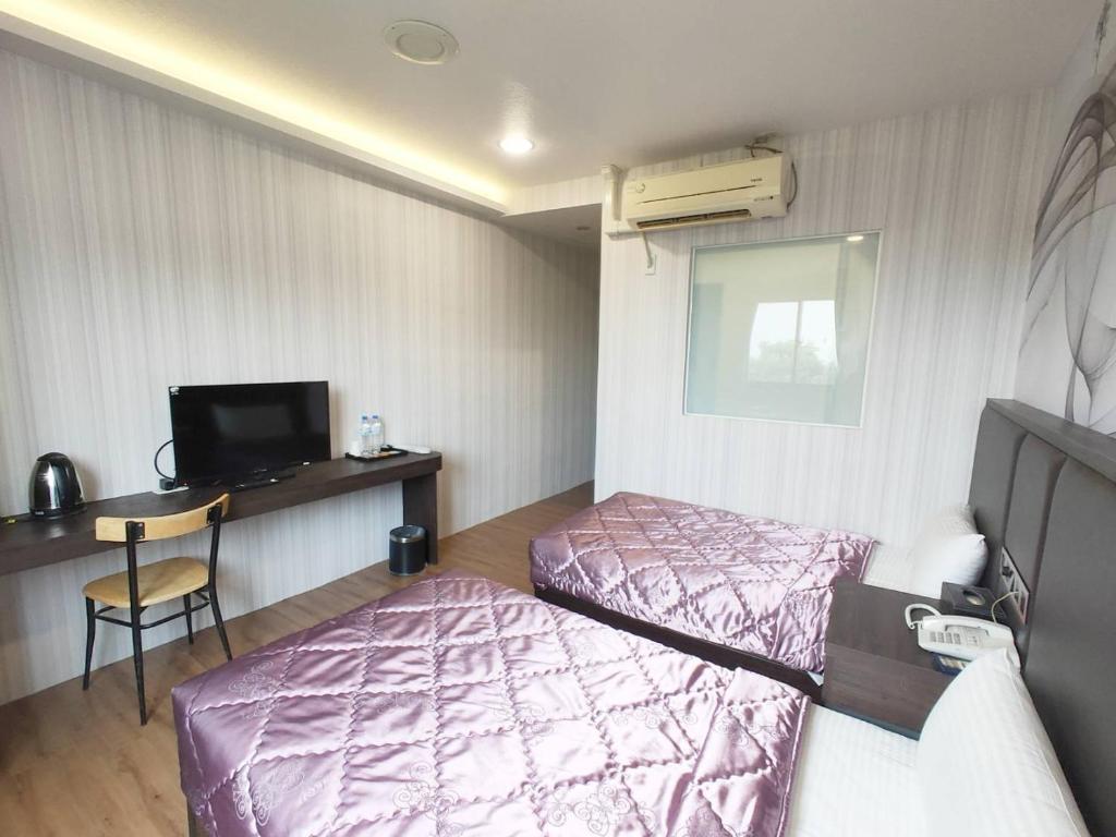 Postel nebo postele na pokoji v ubytování Royal Business Hotel