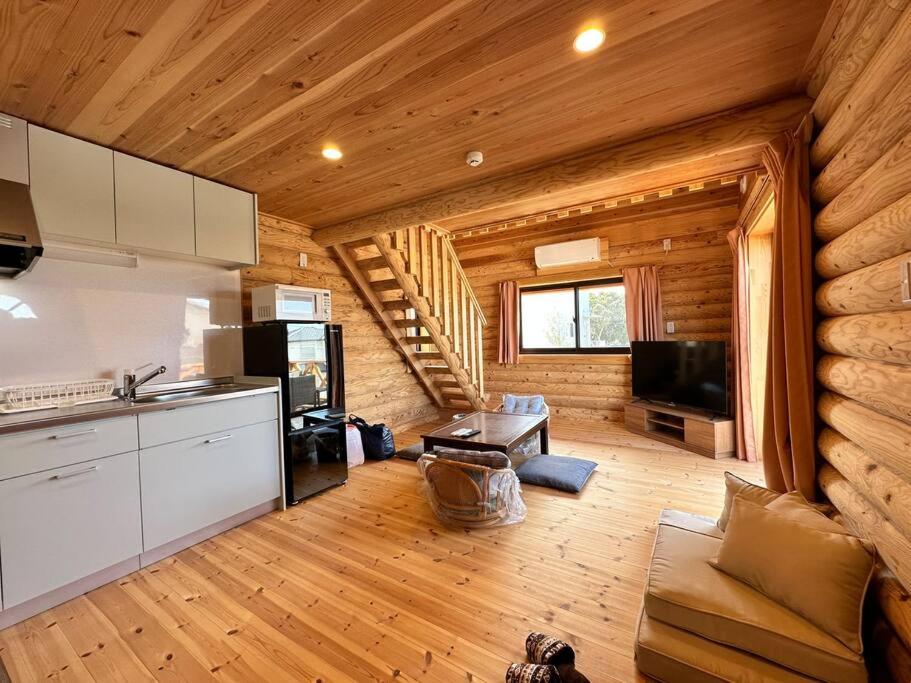 a kitchen and living room of a log cabin at SHIRAHAMA condominium K-32 in Kanayama