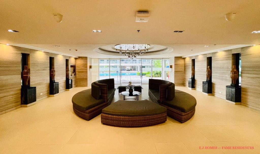 a large room with chairs and a table and a chandelier at MINIMALIST, STYLISH, ELEGANT - at FAME RESIDENCES in Manila