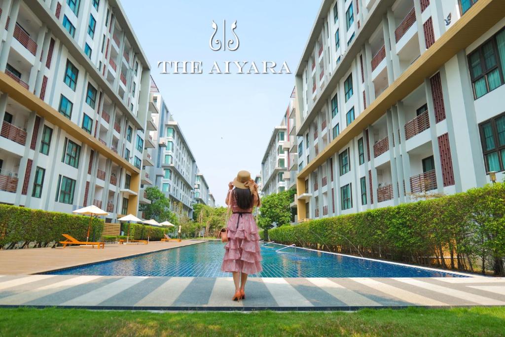 a woman is standing in front of a building at ไอยรา อยุธยา The Aiyara Ayutthaya in Phra Nakhon Si Ayutthaya