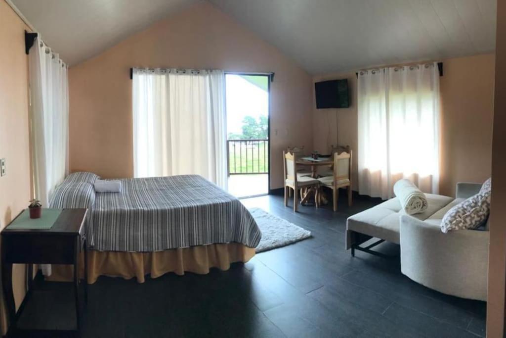 - une chambre avec un lit, un canapé et une table dans l'établissement Cabaña Montaña de Sueños, à Quesada