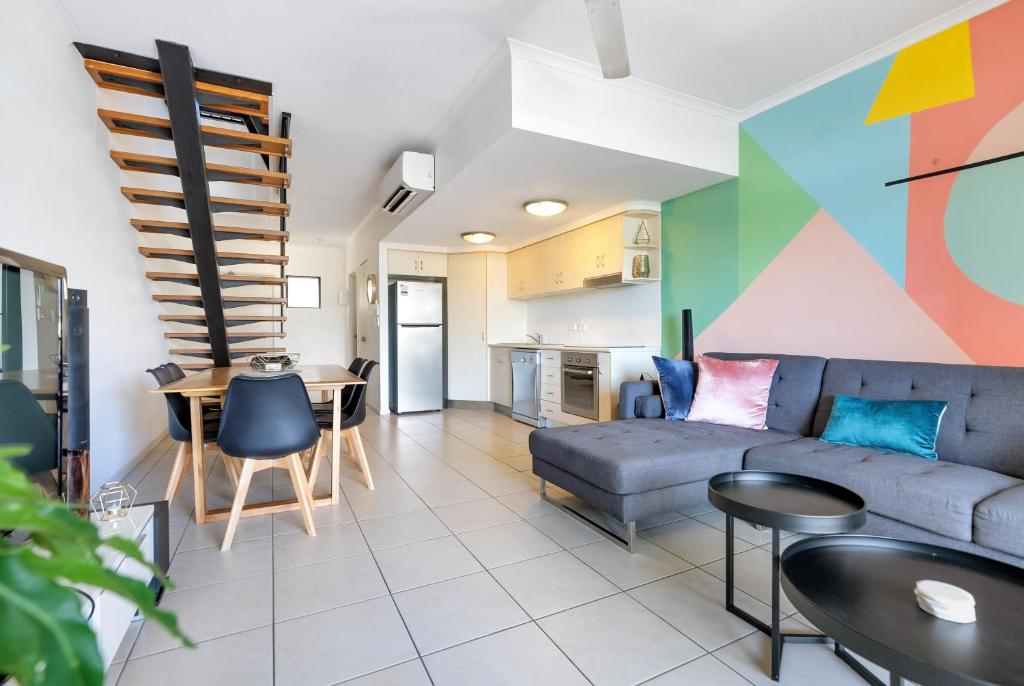 a living room with a couch and a table at The Loft Cairns in Cairns